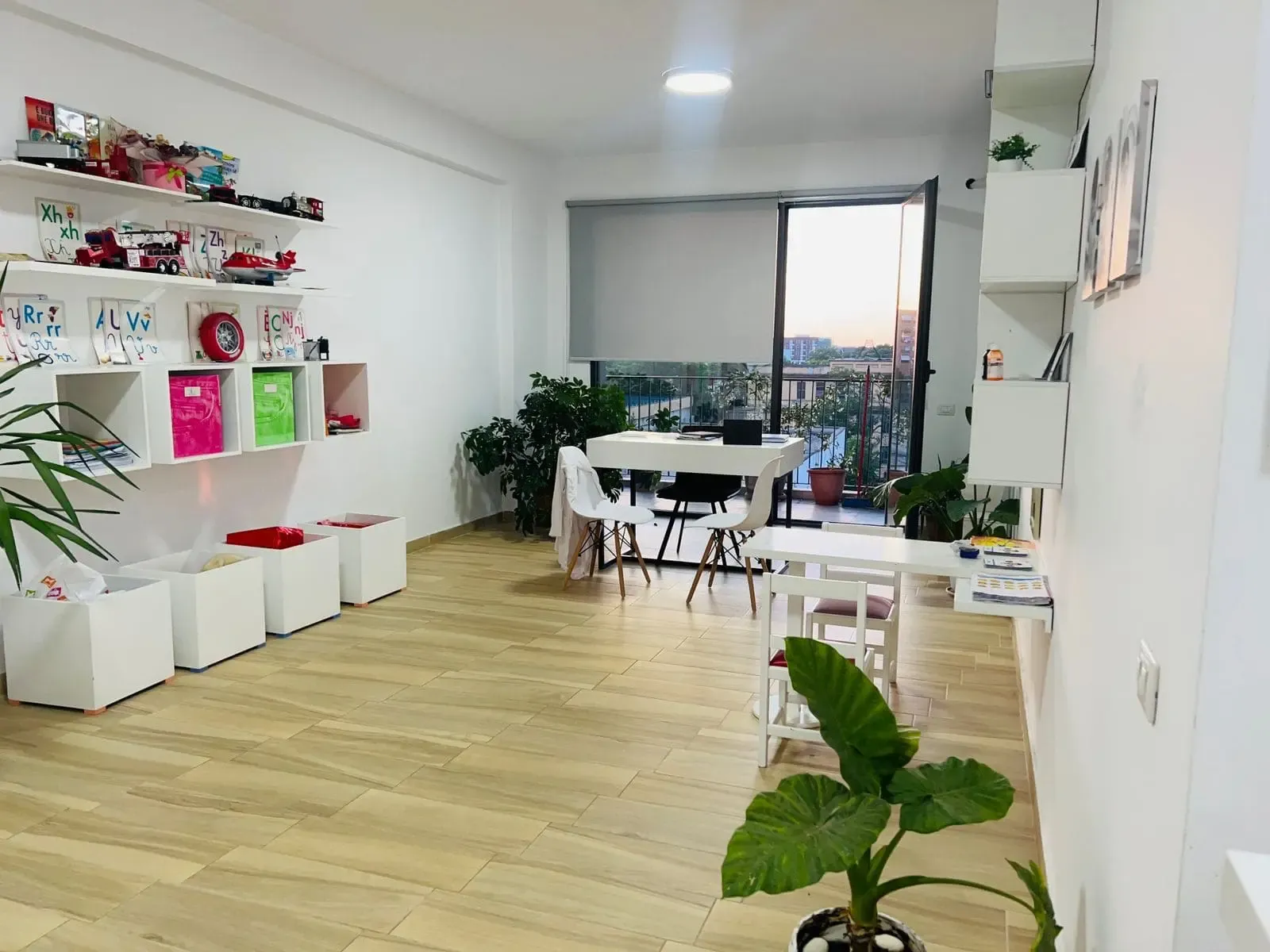 The Speak Up playroom, with a large window and toys on open shelves